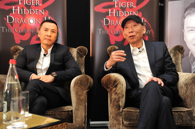 Hong Kong director Woo-ping Yuen, right, speaks next to actor Donnie Yen at a press conference of the movie "Crouching Tiger, Hidden Dragon 2:The Green Destiny" in Cannes, France, 19 May 2013. [Photo: IC]
