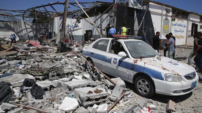 Debris covers the ground and an emergency vehicle after an airstrike at a detention center in Tajoura, east of Tripoli in Libya, Wednesday, July 3, 2019. [Photo: IC]