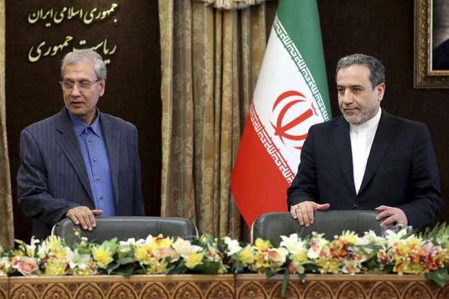 Iran's government spokesman Ali Rabiei, left, and Iranian Deputy Foreign Minister Abbas Araghchi, attend a meeting in Tehran, Iran, Sunday, July 7, 2019. [Photo: IC]