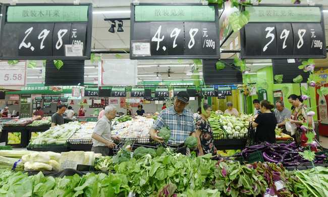 Customers picking up vegetable at a supermarket in Hangzhou, Zhejiang Province, on July 10, 2019. [Photo: IC]