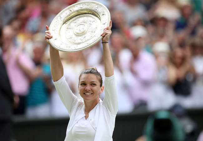 Romania's Simona Halep poses with the trophy as she celebrates after winning the final against Serena Williams of the U.S. [Photo: VCG/Carl Recine]