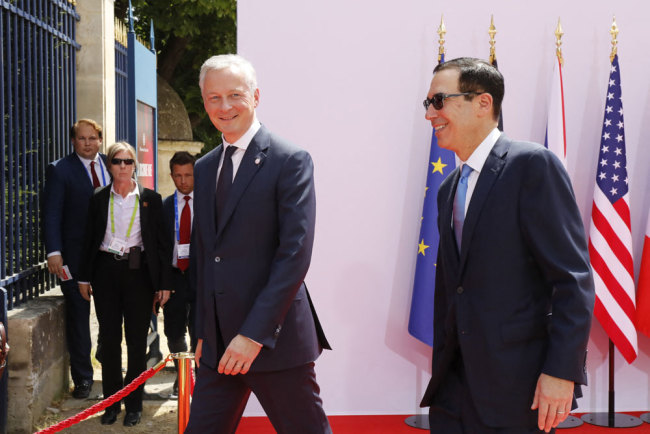 France's Minister of the Economy and Finance Bruno Le Maire greets USA's Secretary of the Treasury Steven Mnuchin before a meeting of the G7 Group of Economy and Finance Ministers and Governors of Central Banks, in Chantilly, France, on July 17, 2019. [Photo: ABACAPRESS.COM Photo via Newscom via IC/Henri Szwarc]