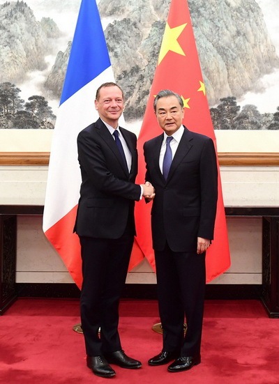 Chinese State Councilor and Foreign Minister Wang Yi meets visiting French president's diplomatic counselor Emmanuel Bonne in Beijing on Friday, July 19, 2019. [Photo: gov.cn]