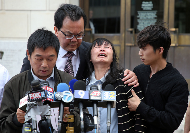 Lifeng Ye, second from right, lets out a wail of grief as her husband Ronggao Zhang, left, the father of slain University of Illinois scholar Zhang Yingying, reads a statement to the media outside the U.S. Courthouse in Peoria, Ill., on June 24, 2019, after a federal jury found Brendt Christensen guilty of kidnapping and murdering Zhang Yingying. [Photo: VCG]