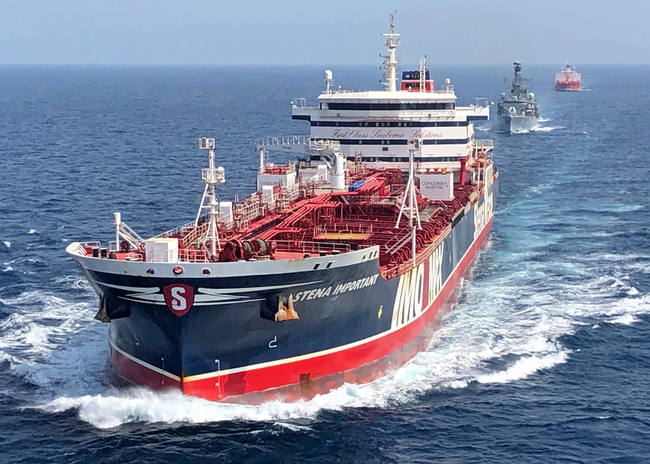 A handout picture provided by the British Ministry of Defence (MOD) shows the Stena Important being accompanied by the British Navy frigate HMS Montrose and the Sea Ploeg vessel through the Strait of Hormuz between the Persian Gulf and the Gulf of Oman, July 25, 2019. [Photo: British Ministry of Defence via EPA/IC]