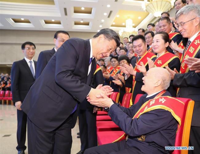 Chinese President Xi Jinping (L, front), also general secretary of the Communist Party of China (CPC) Central Committee and chairman of the Central Military Commission, meets with representatives who are in Beijing to attend a national conference on the work of veterans affairs in Beijing, capital of China, July 26, 2019. Li Keqiang and Wang Huning, both members of the Standing Committee of the Political Bureau of the CPC Central Committee, also attended the meeting. [Photo: Xinhua/Ding Lin]