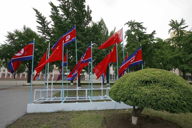 National flags of China and the Democratic People's Republic of Korea (DPRK) are hoisted on a street in Pyongyang, on June 20, 2019. [File Photo: AP/Cha Song Ho via IC]