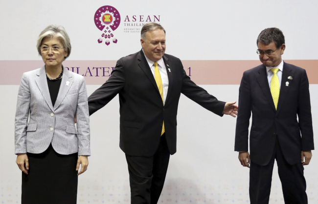 U.S. Secretary of State Mike Pompeo, center, gestures to his Japanese counterpart Taro Kono, right, and South Korean counterpart Kang Kyung-wha after a trilateral meeting on the sidelines of the ASEAN and dialogue partners foreign ministers' meeting in Bangkok, Thailand, Friday, Aug. 2, 2019. [Photo: Jonathan Ernst/Pool Photo via AP]