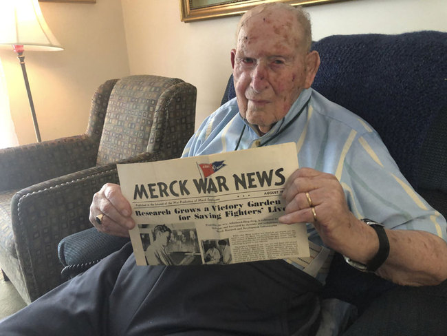 Retired chemist Robert Walton, 103, displays an August 1943 copy of Merck War News which featured a photo and article about his work during World War II helping expand production of penicillin at Merck & Co. in New Jersey, on Monday, July 29, 2019, in Columbus, Ohio. [Photo: AP/Andrew Welsh-Huggins]