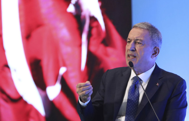 Turkey's Defense Minister Hulusi Akar addresses a meeting of his country's ambassadors, in Ankara, Turkey, Wednesday, Aug. 7, 2019. Akar says his country would like to establish a safe zone in northeast Syria jointly with the United States but would act alone if necessary. [Photo: Turkish Defence Ministry/AP, Pool via IC]