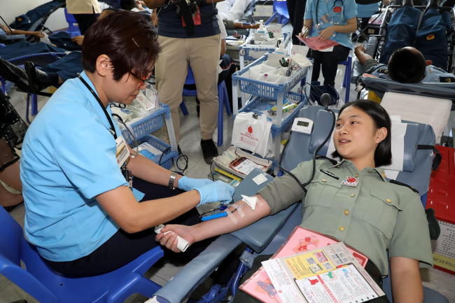 A soldier of the Chinese People's Liberation Army Garrison in the Hong Kong Special Administrative Region donates blood in Hong Kong, August 9, 2019. [Photo: VCG]