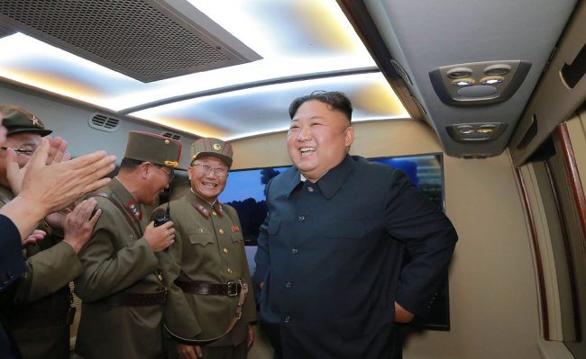 This early August 6, 2019 picture released from the official Korean Central News Agency (KCNA) of Democratic People's Republic of Korea (DPRK) on August 7, 2019 shows DPRK top leader Kim Jong-Un (R) smiling after observing the demonstration fire of two new-type tactical guided missiles at undisclosed western part location of the country. [File photo: KCNA via KNS/AFP via VCG]