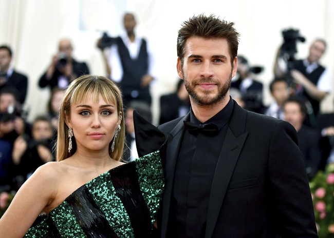 In this May 6, 2019 file photo, Miley Cyrus, left, and Liam Hemsworth attend The Metropolitan Museum of Art's Costume Institute benefit gala celebrating the opening of the "Camp: Notes on Fashion" exhibition in New York. [Photo: AP]