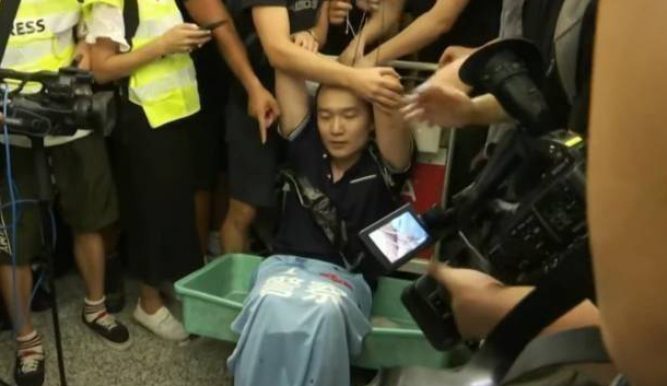 Video screenshot shows that Fu Guohao, a reporter with the Global Times, was assaulted and forcibly held by the protesters at the Hong Kong International Airport. [Photo: China Plus]