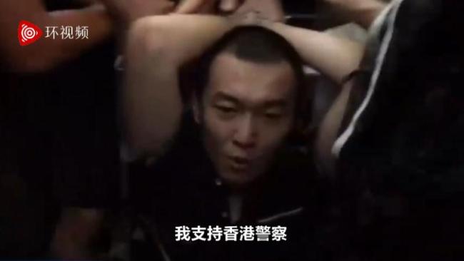 Fu Guohao, a journalist, expresses support for Hong Kong police, with his hands tied up, at Hong Kong International Airport, on Tuesday, August 13, 2019. [Photo: Video screenshot from Global Times] 