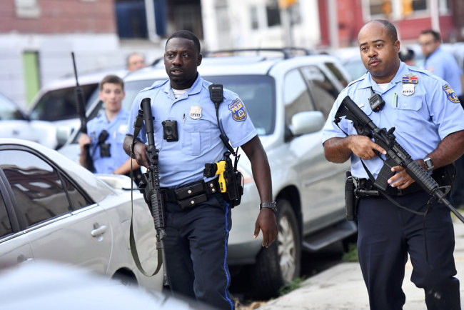 Police officers congregate outside a residence while responding to a shooting on August 14, 2019 in Philadelphia, Pennsylvania. [Photo: Getty Images/Mark Makela]