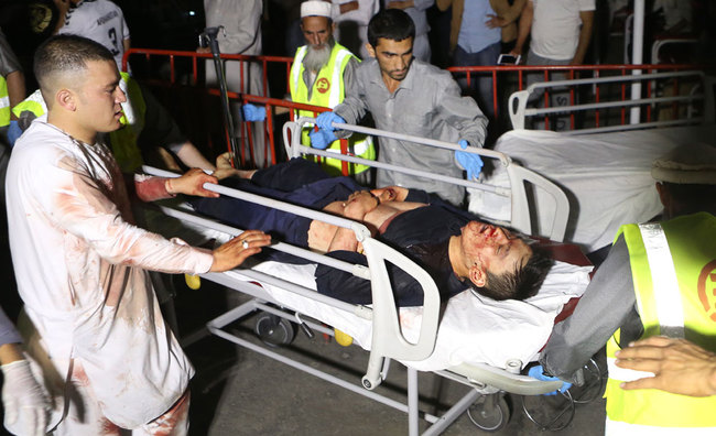 Afghan health workers carry a wounded man into the hospital after a suicide attacker exploded his explosive vest among a wedding ceremony in a wedding hall in Kabul, Afghanistan, August 18, 2019. [Photo: EPA via IC/Jawad Jalali]