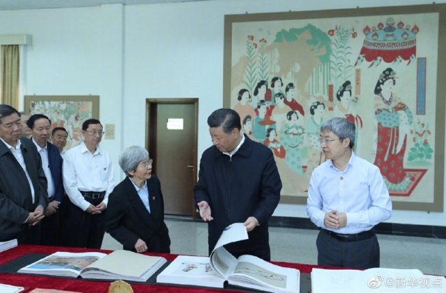 Chinese President Xi Jinping visited exhibitions of relics and research results and attended a symposium with experts, scholars and representatives from cultural units in the Dunhuang Academy in Dunhuang during his inspection tour of northwest China's Gansu Province, Aug. 19, 2019. [Photo: Xinhua/Ju Peng]