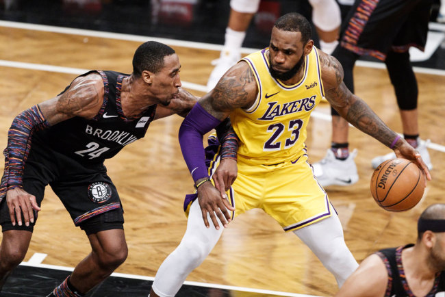The Lakers' LeBron James (R) tries to drive to the basket past the Nets' Rondae Hollis-Jefferson (L) during match between the Los Angeles Lakers and the Brooklyn Nets at the Barclays Center in Brooklyn, New York, USA, December 18, 2018. [File photo: EPA via IC/Justin Lane]