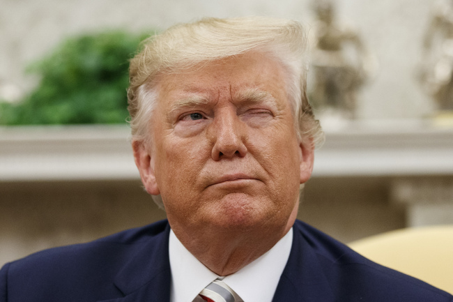 President Donald Trump winks at a journalist while speaking during a meeting with Romanian President Klaus Iohannis in the Oval Office of the White House, Tuesday, Aug. 20, 2019, in Washington. [Photo: AP via IC/Alex Brandon]