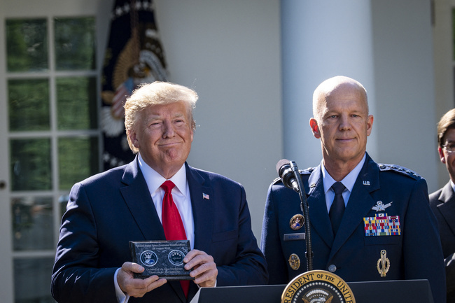 President Trump displays a gift from the new Space Command Commander, Air Force Gen. John Raymond (right) during a ceremony establishing the U.S. Space Command in the Rose Garden of the White House on Aug. 29, 2019 in Washington, D.C. U.S. Air Force Gen. John Raymond will serve as the first head of Space Command (SPACECOM). [Photo: ABACAPRESS.COM via IC/Pete Marovich]