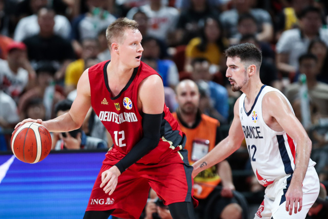  #12 Robin Benzing of the Germany National Team in action against #12 Nando De Colo of the France National Team during the 1st round of 2019 FIBA World Cup at Shenzhen Bay Sports Center on September 01, 2019 in Shenzhen, China. [Photo: Getty Images via VCG/Zhong Zhi]