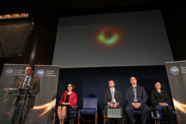 In this file photo taken on April 10, 2019, (L-R) Event Horizon Telescope Director Sheperd Doeleman, National Science Foundation Director France Cordova, University of Arizona Associate Professor of Astronomy Dan Marrone, University of Waterloo Associate Professor Avery Broderick and University of Amsterdam Professor of Theoretical High Energy Astrophysics Sera Markoff reveal the first photograph of a black hole during a news conference organized at the National Press Club in Washington, DC. [Photo: AFP]