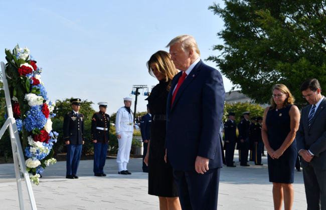 U.S. President Donald Trump and First Lady Melania Trump, with US Secretary of Defense Mark Esper (R) and his wife Leah Esper (2nd R), lay a wreath during a ceremony marking the 18th anniversary of the 9/11 attacks on September 11, 2019, at the Pentagon in Washington, DC. [Photo: AFP/Nicholas Kamm]