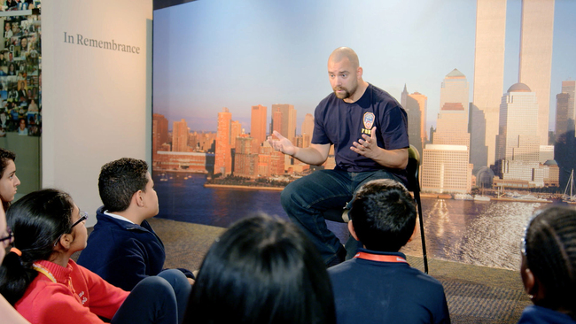 This image released by HBO shows a New York City Fireman speaking to children in a scene from the documentary "What Happened on September 11," a short film aimed at young people to explain to them what happened on Sept. 11, 2001. The program debuts on Wednesday.  [Photo: AP]