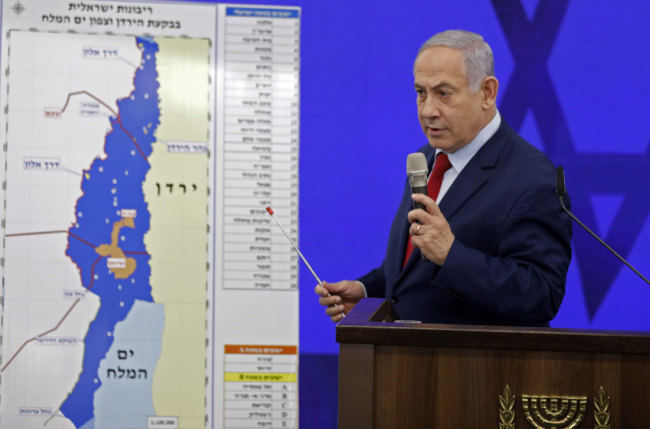 Israeli Prime Minister Benjamin Netanyahu speaks before a map of the Jordan Valley as he gives a statement in Ramat Gan, near the Israeli coastal city of Tel Aviv, on September 10, 2019. [Photo: AFP/Menahem Kahana]