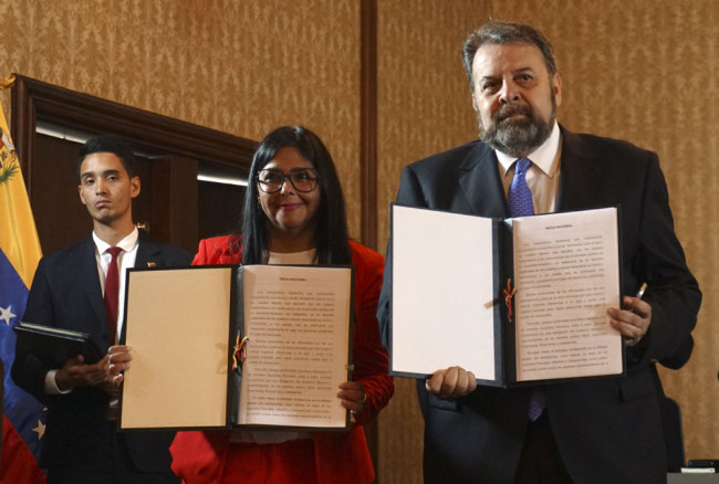 This handout picture released by Venezuela's Foreign Ministry press office shows Venezuela's Vice-President Delcy Rodriguez (L) and Venezuelan opposition deputy Timoteo Zambrano (R) after signing an agreement for the government's return to Parliament, during a meeting at the Foreign Ministry in Caracas, Venezuela, on September 16, 2019. [Photo: Venezuela's Foreign Ministry/AFP]