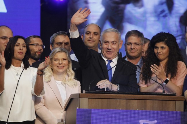 Israeli Prime Minister Benjamin Netanyahu (C) waves to supporters alongside his wife Sara Netanyahu (C-L) at his Likud party's electoral campaign headquarters early on September 18, 2019. [Photo: IC]