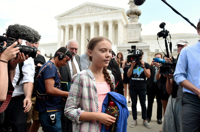 Swedish teen climate activist Greta Thunberg walks outside the US Supreme Court to support the children’s climate lawsuit against the US on September 18, 2019 in Washington, DC. [Photo: AFP]