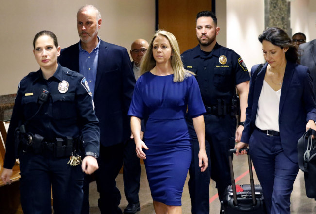 Former Dallas police officer Amber Guyger, center, arrives for the first day of her murder trial in the 204th District Court at the Frank Crowley Courts Building in Dallas, Monday, Sept. 23, 2019. [Photo: AP]