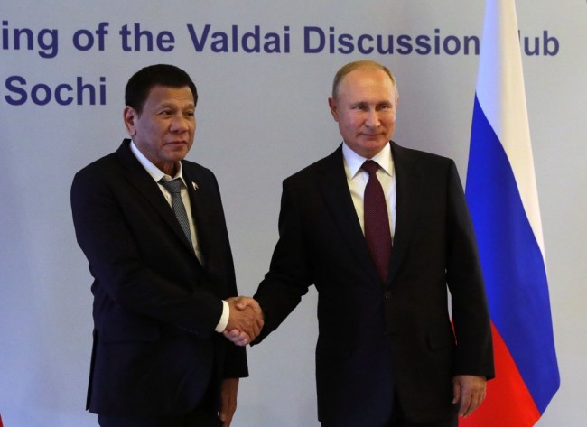Russian President Vladimir Putin (R) shakes hands with Philippine's President Rodrigo Duterte prior to their meeting at the Valdai Discussion Club in Sochi on October 3, 2019. [Photo: AFP]