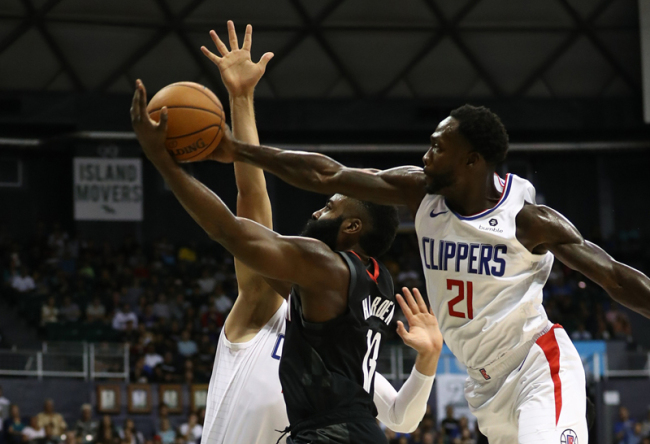 James Harden, center, of the Houston Rockets has his shot swatted away by Patrick Beverley, right, of the Los Angeles Clippers during the first half of their game at the Stan Sheriff Center on October 3, 2019 in Honolulu, Hawaii. [Photo: VCG]