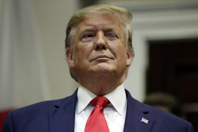 President Donald Trump winks as he listens before a trade agreement signing with Japan in the Roosevelt Room of the White House, Monday, Oct. 7, 2019, in Washington. [File Photo: AP/Evan Vucci]