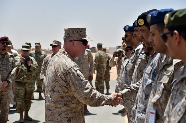 In this file photo taken on July 18, 2019, US Marine Corps General Kenneth F. McKenzie Jr. (C-L), Commander of the US Central Command, shakes hands with Saudi military officers during his visit to a military base in al-Kharj in central Saudi Arabia. [File Photo: AFP]