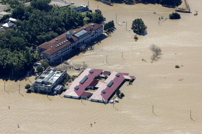 This aerial view shows the flooded Kawagoe Kings Garden nursing home besides the Oppegawa river in Kawagoe, Saitama prefecture on October 13, 2019, one day after Typhoon Hagibis swept through central and eastern Japan. [Photo: AFP/Jiji Press/STR]