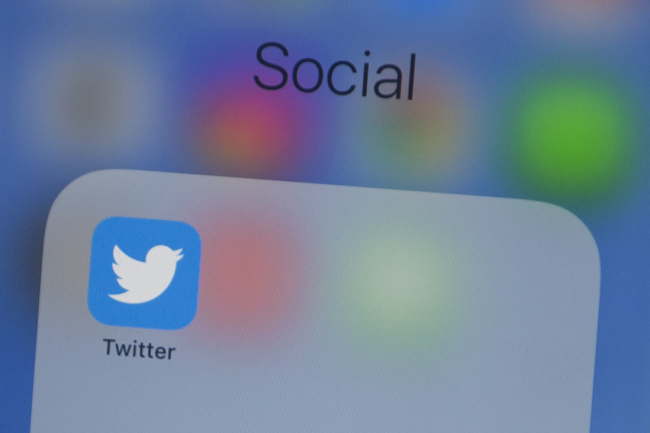 In this file photo taken on July 10, 2019, the Twitter logo is seen on a phone in this photo illustration in Washington, DC. Twitter said on October 15, 2019, world leaders are "not above" the rules of the online platform and could see their messages removed or demoted for egregious conduct violating its terms of service.[File Photo: Alastair Pike/AFP]