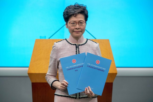 Hong Kong Chief Executive Carrie Lam poses with the policy address during a press conference at the Legislative Council in Hong Kong, on Wednesday, Oct. 16, 2019. [Photo: IC]