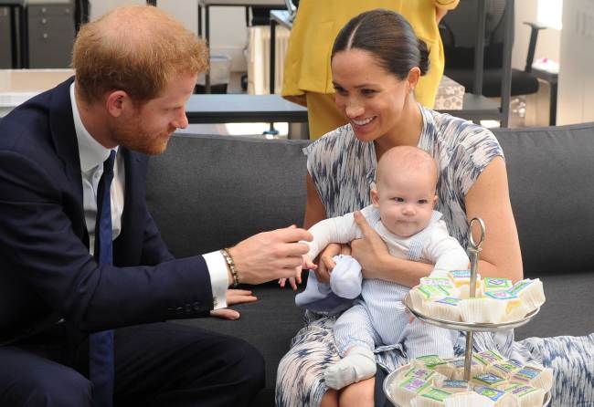 Britain's Duke and Duchess of Sussex, Prince Harry and his wife Meghan hold their baby son Archie as they meet with Archbishop Desmond Tutu (unseen) at the Tutu Legacy Foundation in Cape Town on September 25, 2019. [Photo: AFP/Henk Kruger]