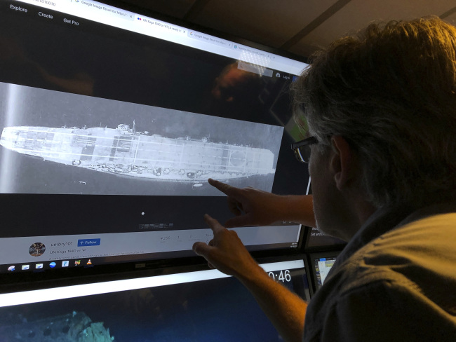 In this Wednesday, Oct. 16, 2019, photo, Vulcan Inc. director of subsea operations of the Petrel, Rob Kraft looks at images of the Japanese aircraft carrier Kaga, off Midway Atoll in the Northwestern Hawaiian Islands. Deep-sea explorers scouring the world's oceans for sunken World War II ships are honing in on a debris field deep in the Pacific. The research vessel called the Petrel is launching underwater robots about halfway between the U.S. and Japan in search of warships from the Battle of Midway. [Photo: AP/Caleb Jones]