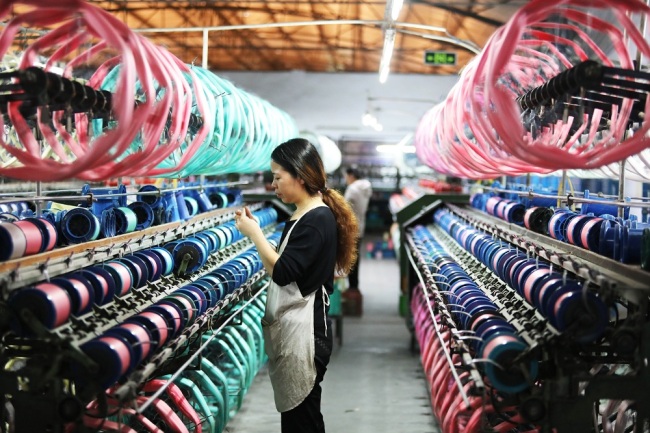 A worker on duty at a silk mill in Chongqing Municipality on Thursday, October 24, 2019. [Photo: IC]
