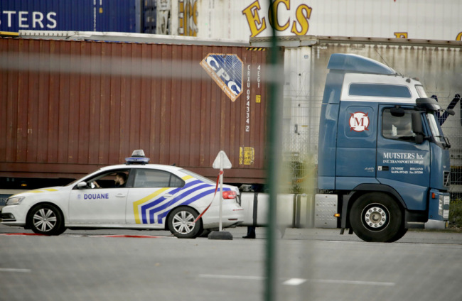 A customs police car parks next to a truck waiting to pass through a scanning tunnel at the Port of Zeebrugge, in Zeebrugge, Belgium, Thursday, October 24, 2019. [Photo: IC]