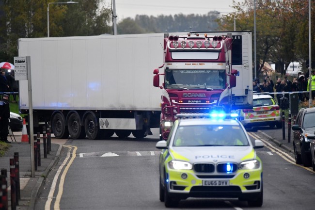 The taken on October 23, 2019 shows Police officers driving away a lorry in which was discovered 39 dead bodies, at Waterglade Industrial Park in Grays, east of London, on October 23, 2019. [Photo: AFP/ Ben STANSALL] 