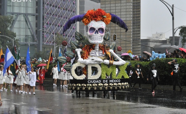 People take part in the Day of the Dead parade along Reforma avenue in Mexico City, on October 27, 2019. [Photo: AFP/CLAUDIO CRUZ ]