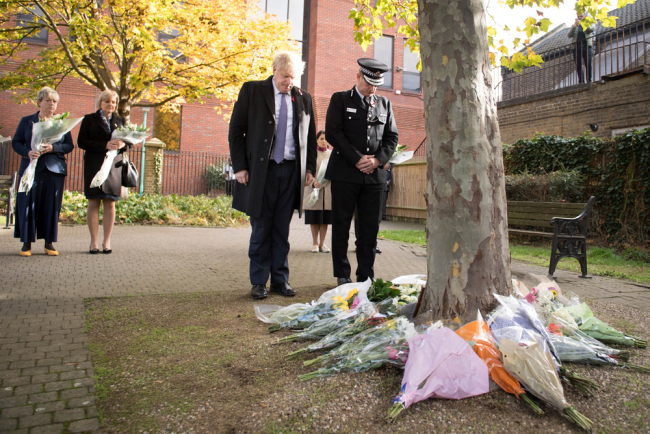 Britain's Prime Minister Boris Johnson stands with Chief Constable of Essex Police, Ben-Julian Harrington (R), after they laid flowers, during a visit to Thurrock Council Offices in Thurrock, east of London on October 28, 2019, following the October 23, 2019, discovery of 39 bodies concealed in a lorry. [Photo: AFP/POOL/Stefan Rousseau]