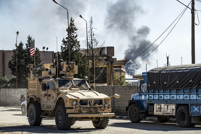 File Photo: A US military armoured vehicle drives in a patrol past an oil well in Rumaylan (Rmeilan) in Syria's northeastern Hasakeh province on November 6, 2019. [Photo: AFP/Delil SOULEIMAN]