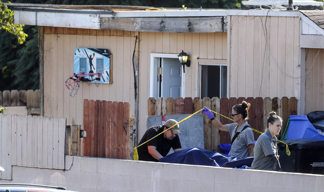 A body is carried out on a gurney at the home where two adults and three children died from gunshot wounds during a domestic shooting in the Paradise Hills area in San Diego, Calif., Saturday, Nov. 16, 2019. [Photo: AP]